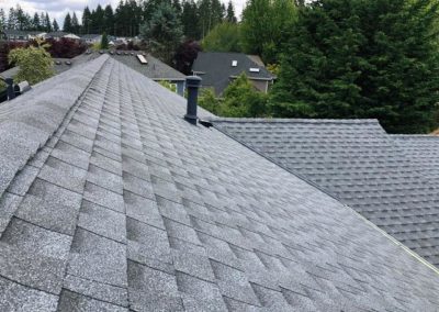 A shingled roof installation in a residential neighborhood.